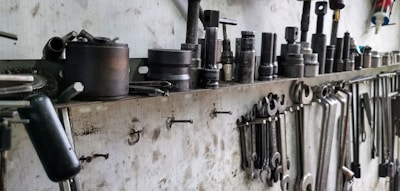 a bunch of tools are hanging on a wall