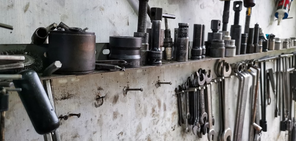 a bunch of tools are hanging on a wall