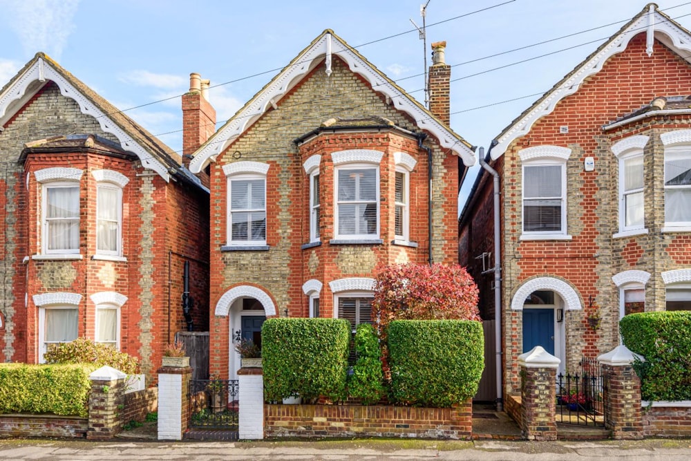 a row of brick houses with white windows