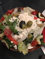 A vibrant salad bursting with colorful peppers, olives, and feta cheese.