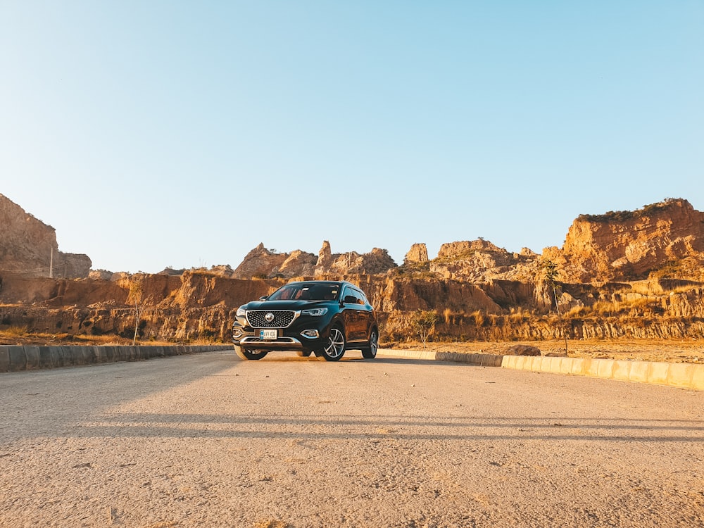 a blue suv parked on the side of a road