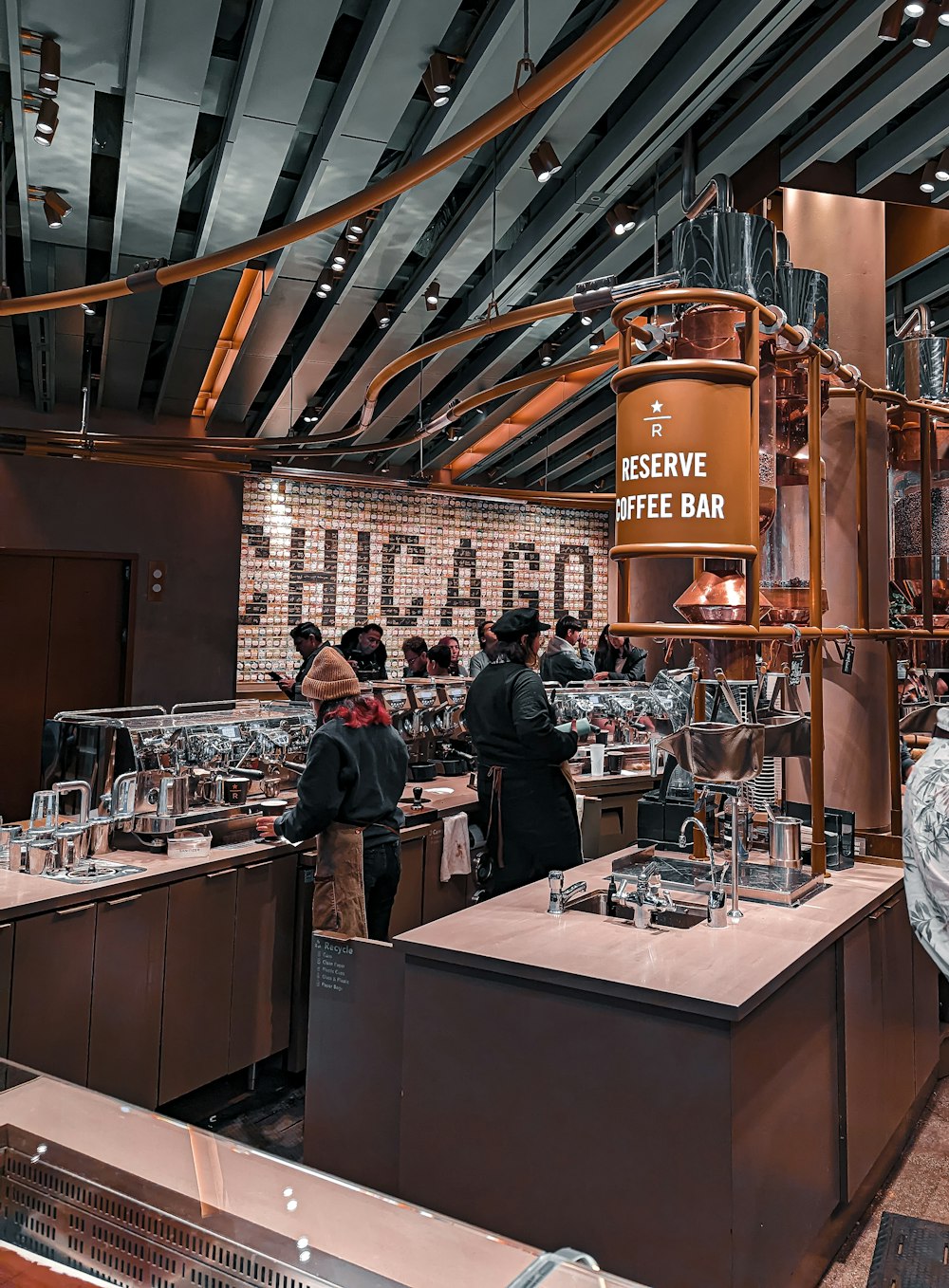 a group of people standing around a coffee bar