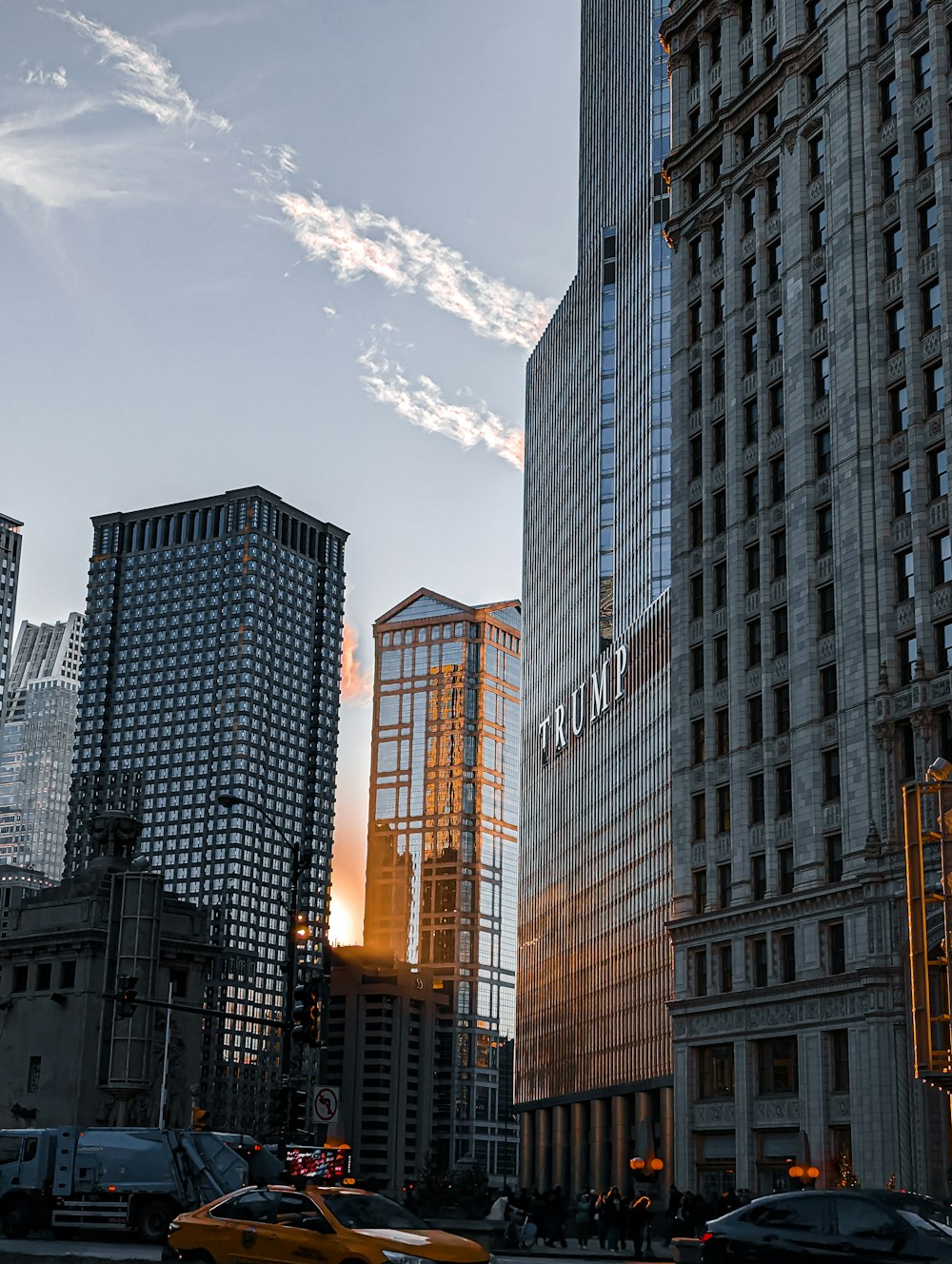 a taxi cab driving down a street next to tall buildings