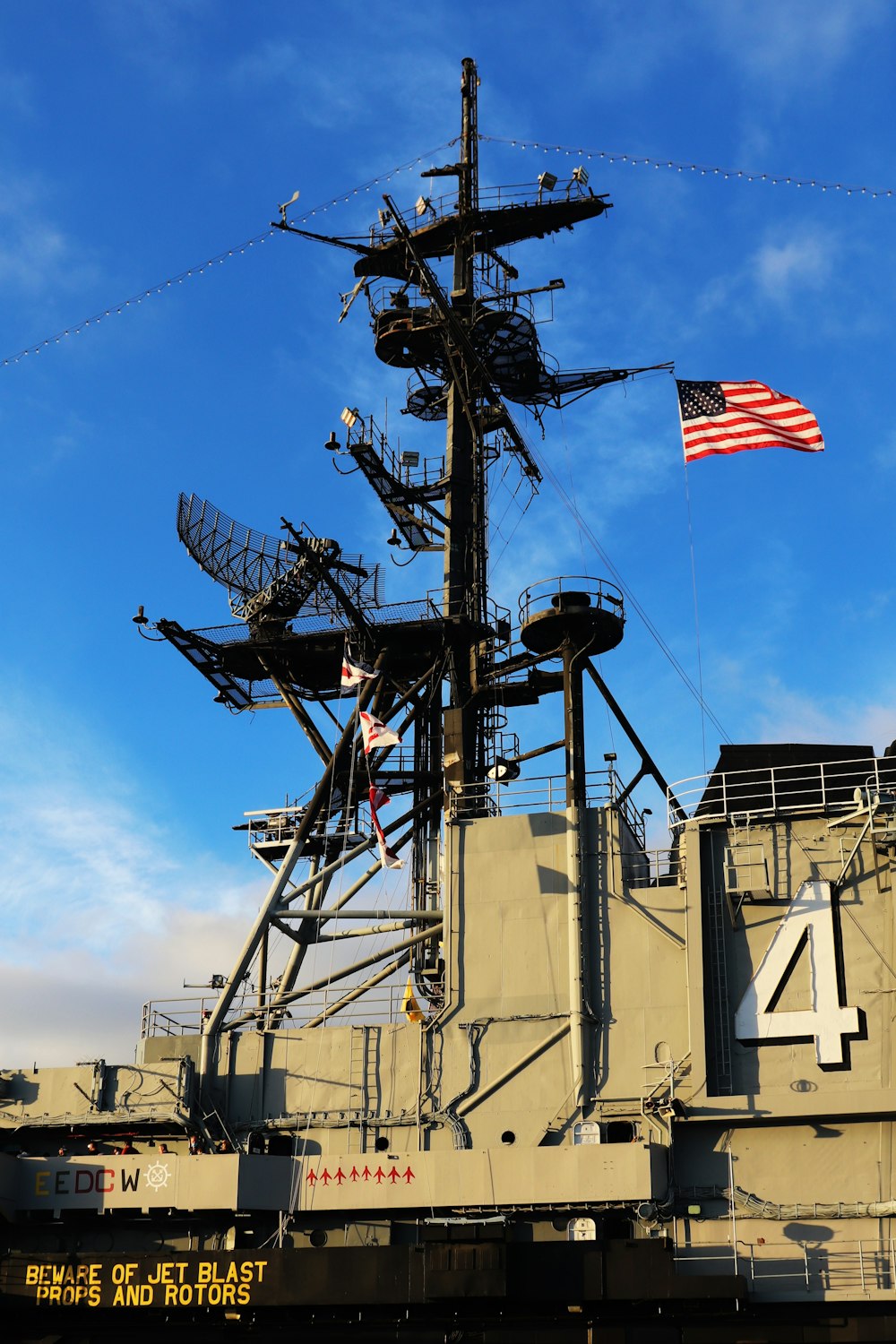 a large military ship with a flag on top of it