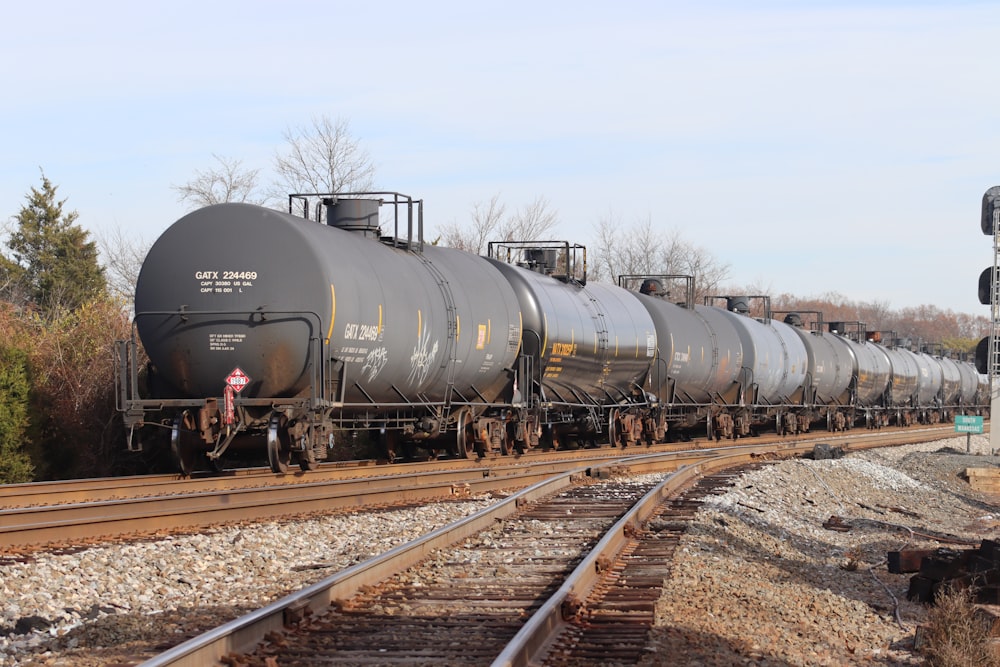 a train with a lot of tanks on the tracks