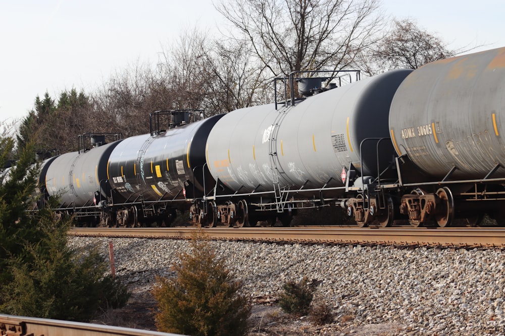 a train on a train track with trees in the background