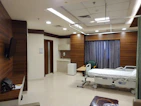 a hospital room with a bed and a television
