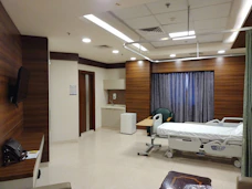 a hospital room with a bed and a television