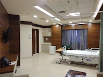 a hospital room with a bed and a television