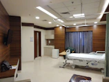a hospital room with a bed and a television