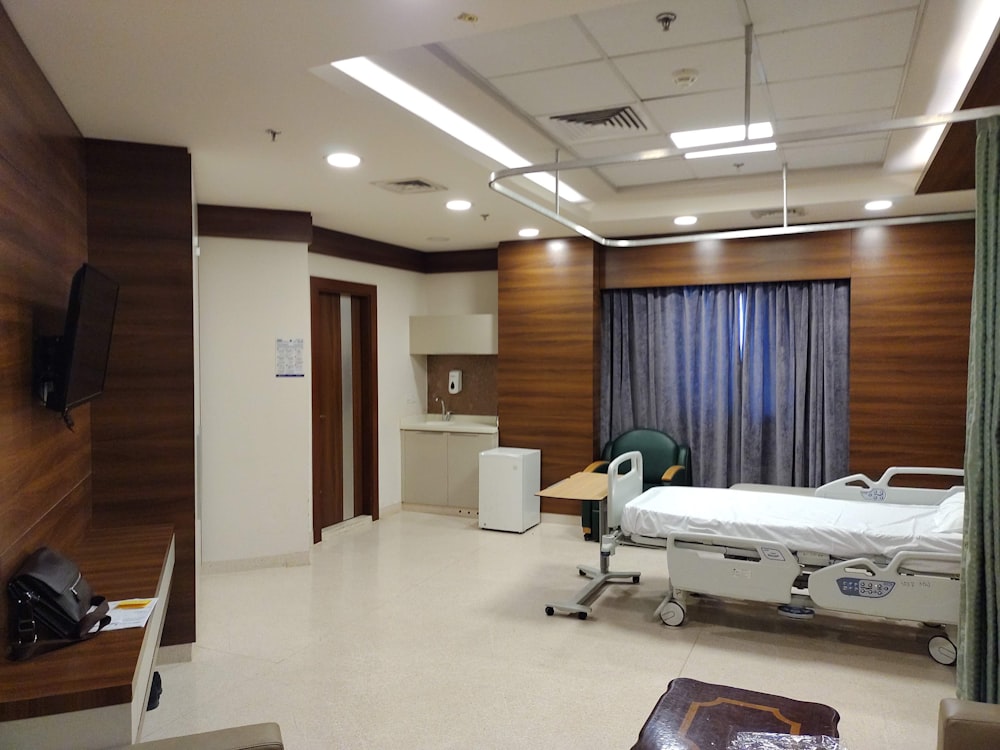 a hospital room with a bed and a television