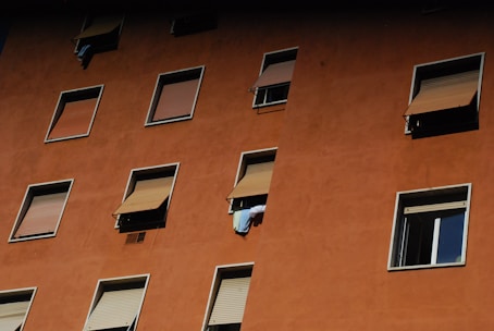 Close-up of a freshly painted building facade under bright sunlight in Treviso.