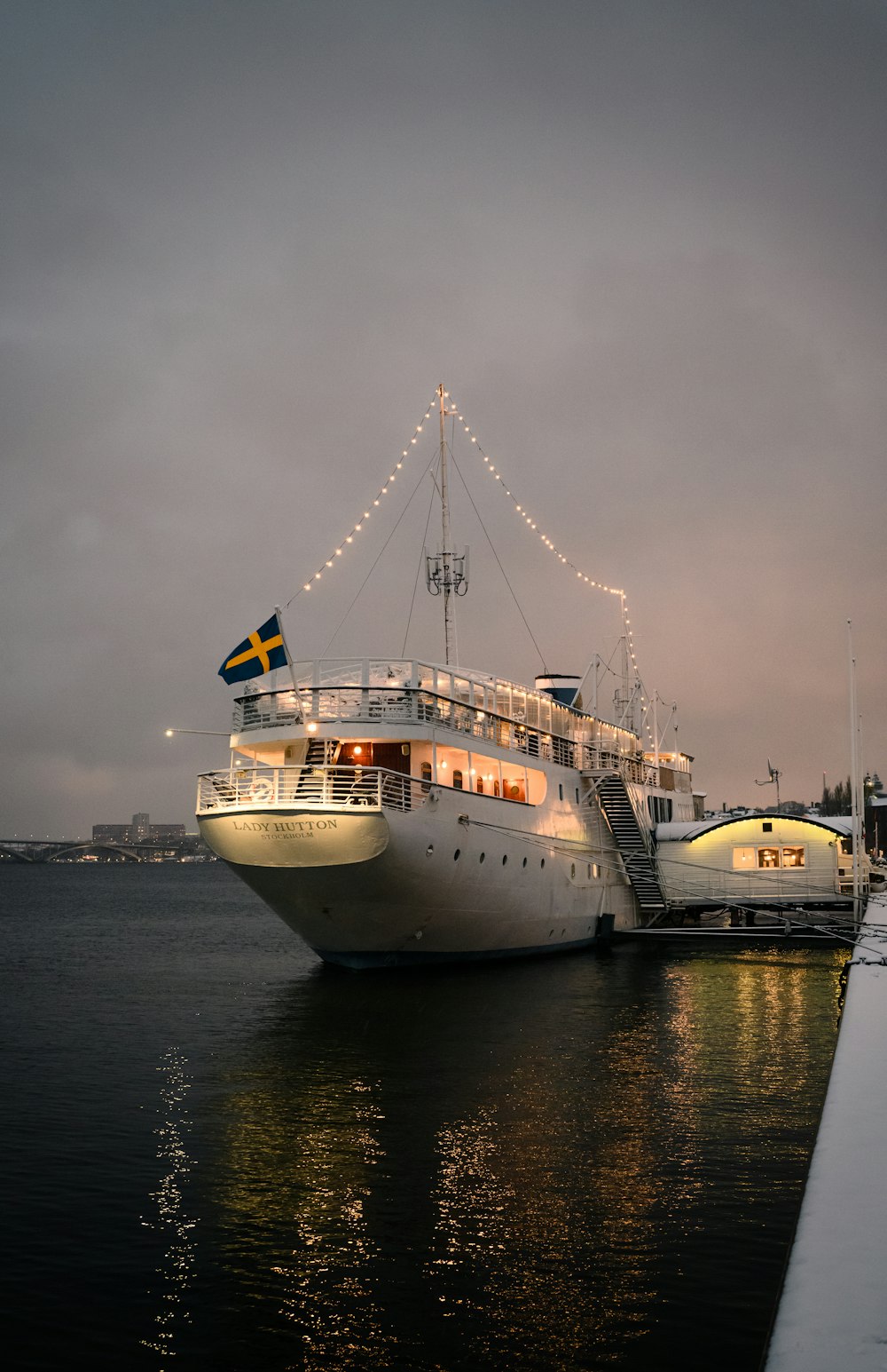 a large white boat sitting next to a dock