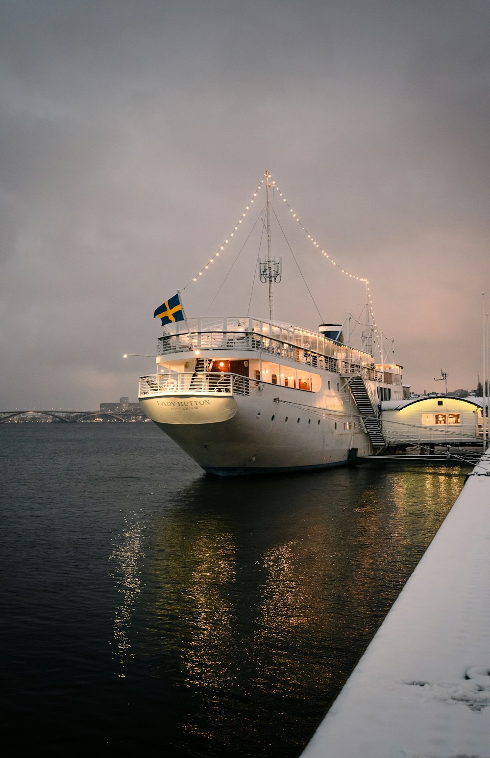 a large white boat sitting next to a pier