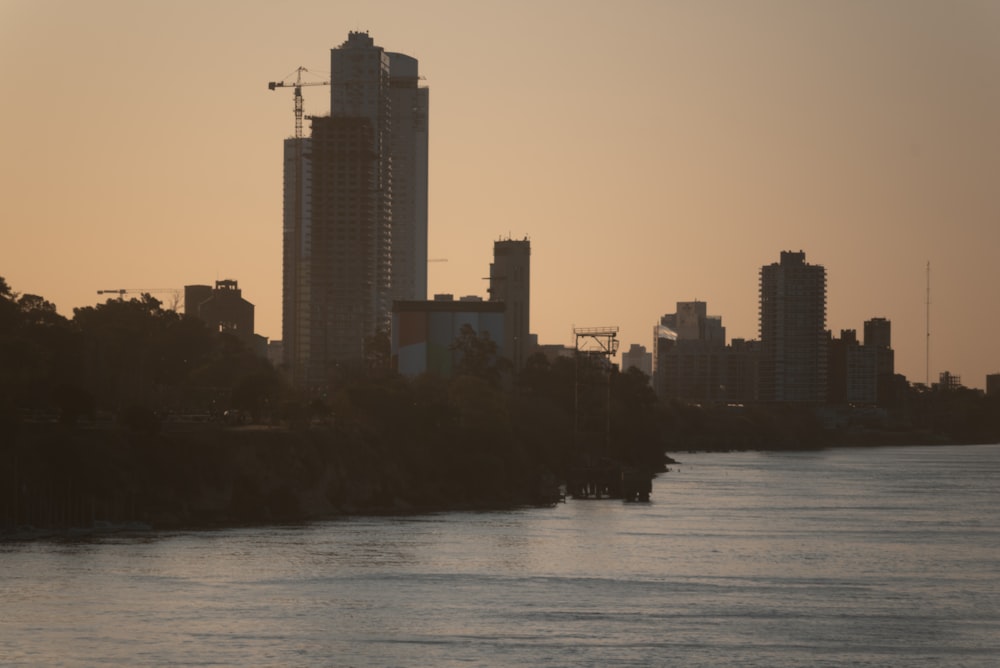 a body of water with a city in the background