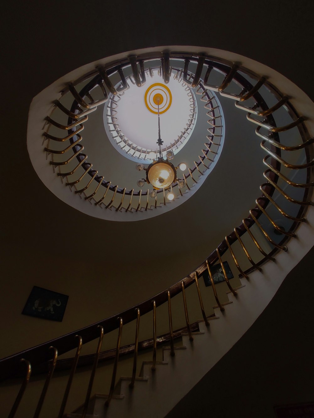 a spiral staircase in a building with a clock on the wall