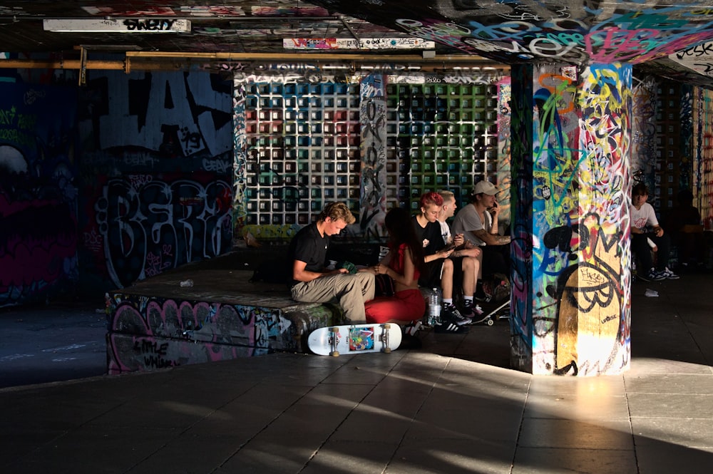 a group of young men sitting on top of a bench