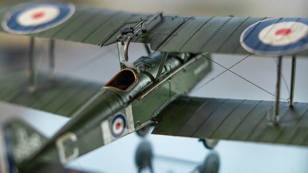 a model of a green airplane with a propeller