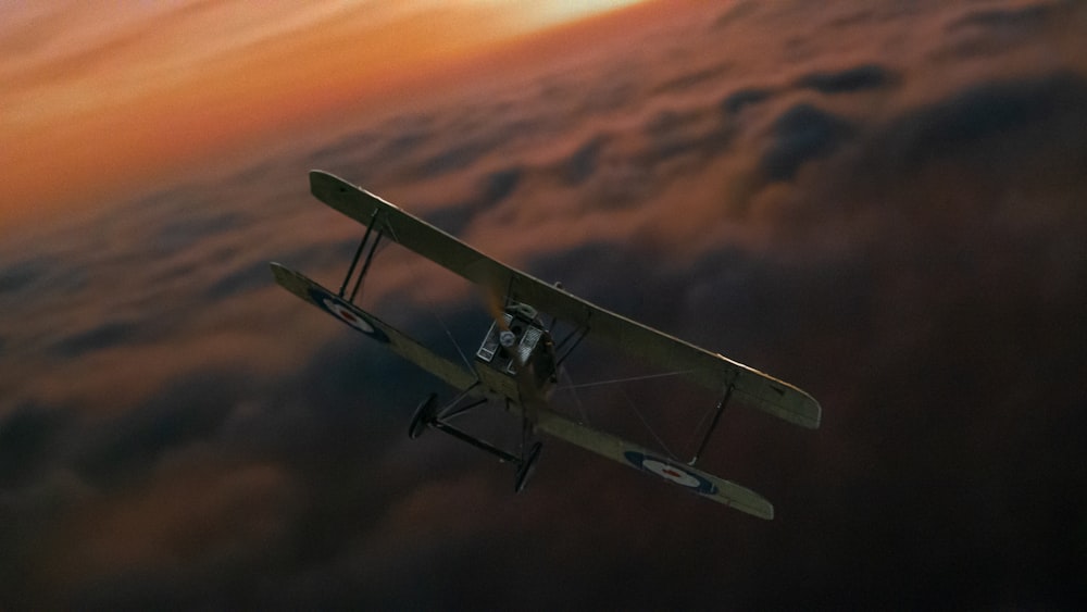 a small airplane flying through a cloudy sky