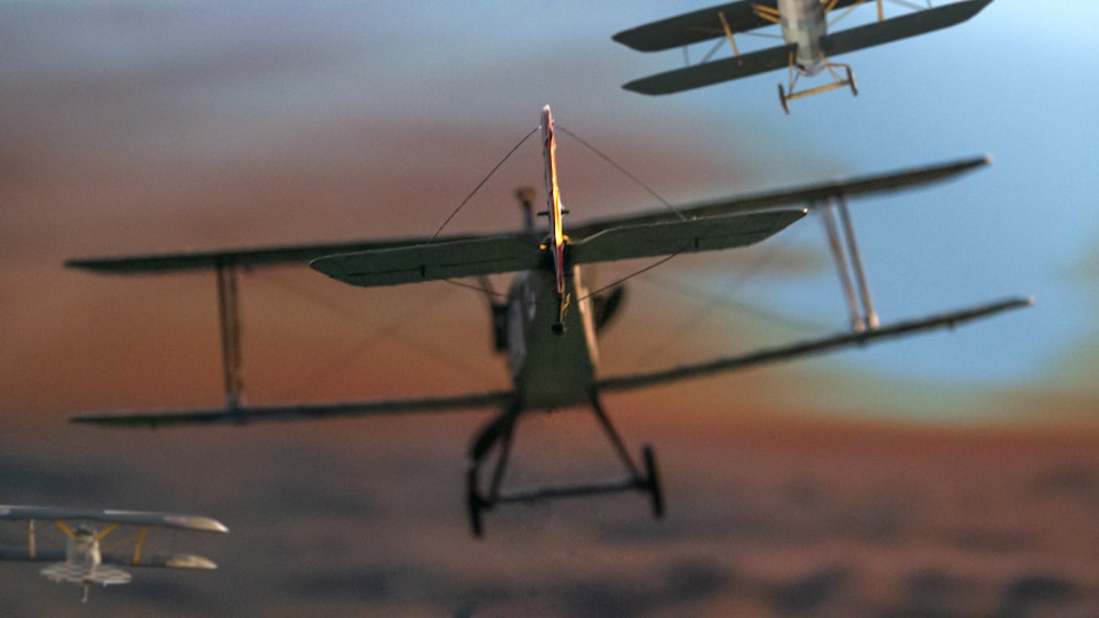 a couple of small planes flying through a cloudy sky