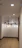 A modern hallway illuminated by elegant mini pendant lights hanging from the ceiling.