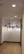 A modern hallway illuminated by elegant mini pendant lights hanging from the ceiling.