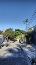 Street view showing quiet neighborhood lined with mature trees.