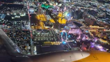 Aerial night view of Balneário Camboriú with glowing neon city lights and the FG Big Wheel illuminated.