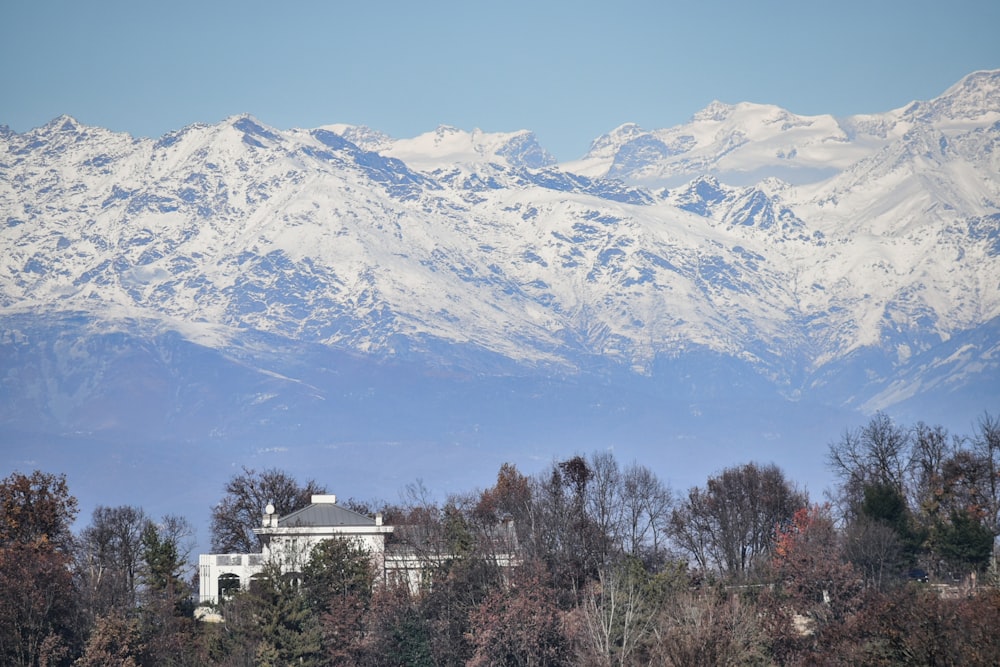 a large mountain range with a house in the foreground