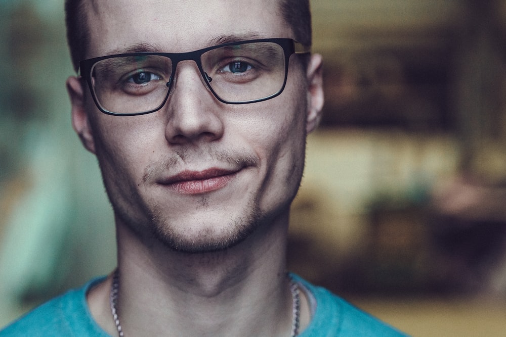 a man wearing glasses and a blue shirt