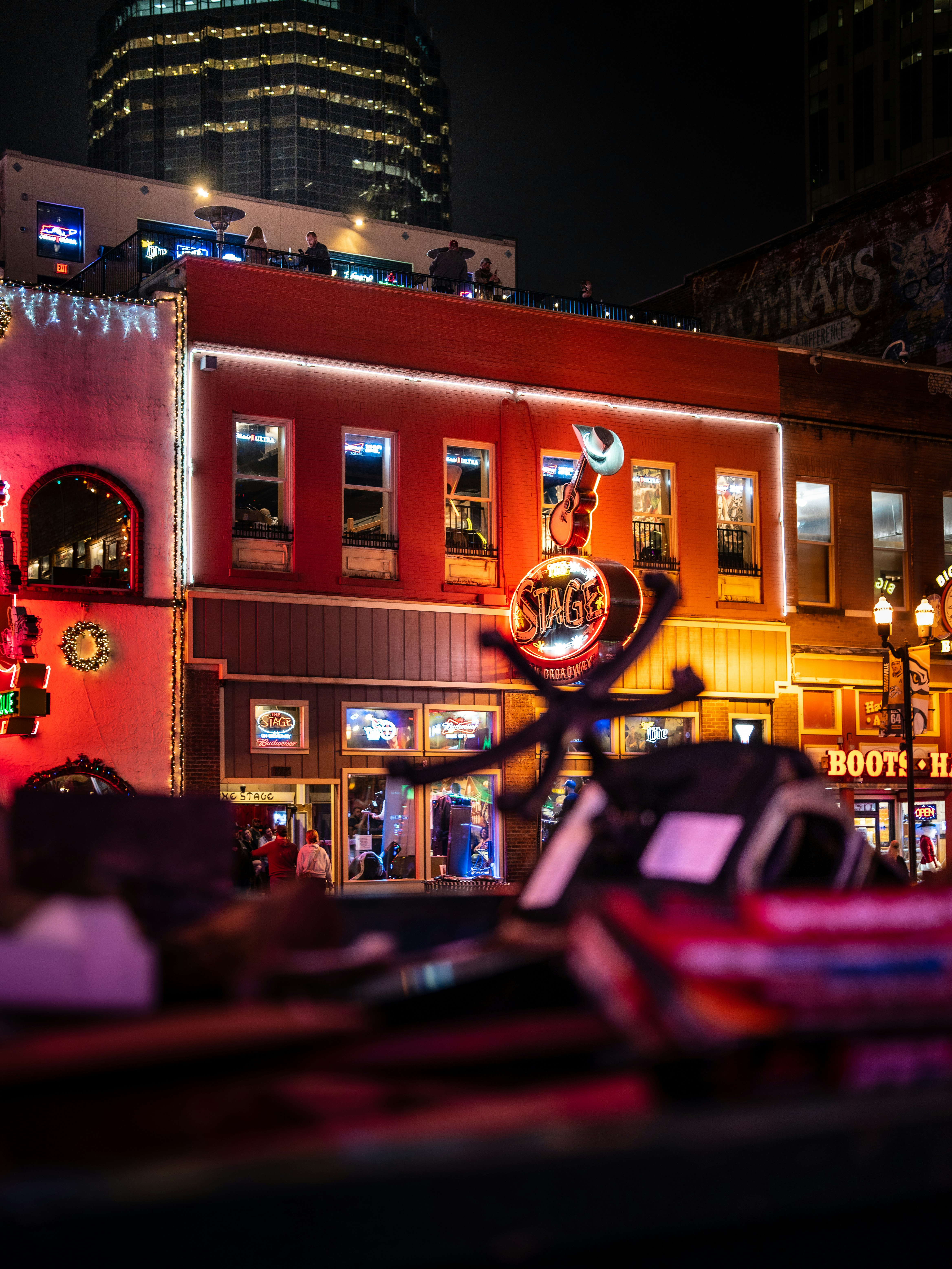 a city street at night with a building in the background