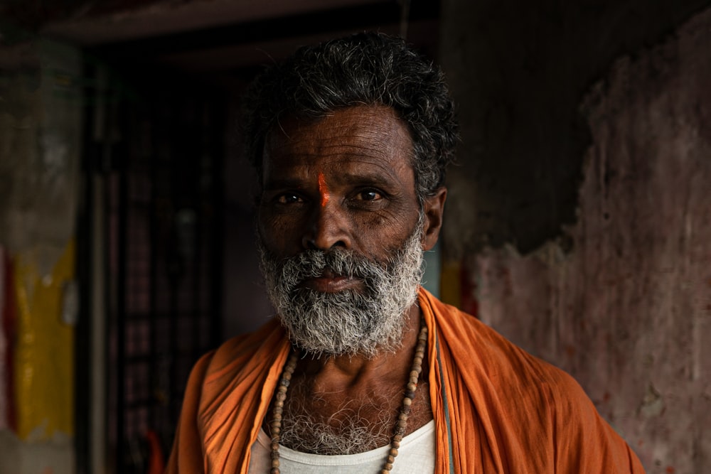 a man with a beard wearing a necklace