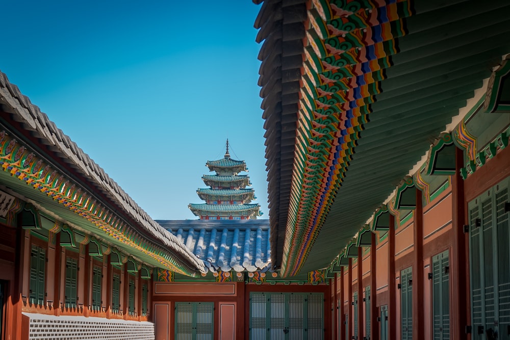 a view of a building with a tall tower in the background