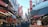 A traveler exploring a vibrant street market in Japan, filled with colorful stalls and local delicacies.