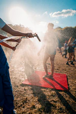A misting fan cooling an outdoor event in Banda Aceh under bright sunlight.