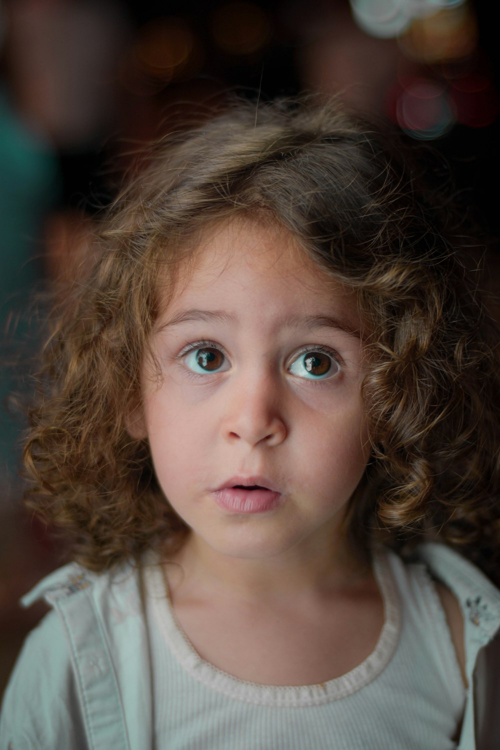 a close up of a child with curly hair