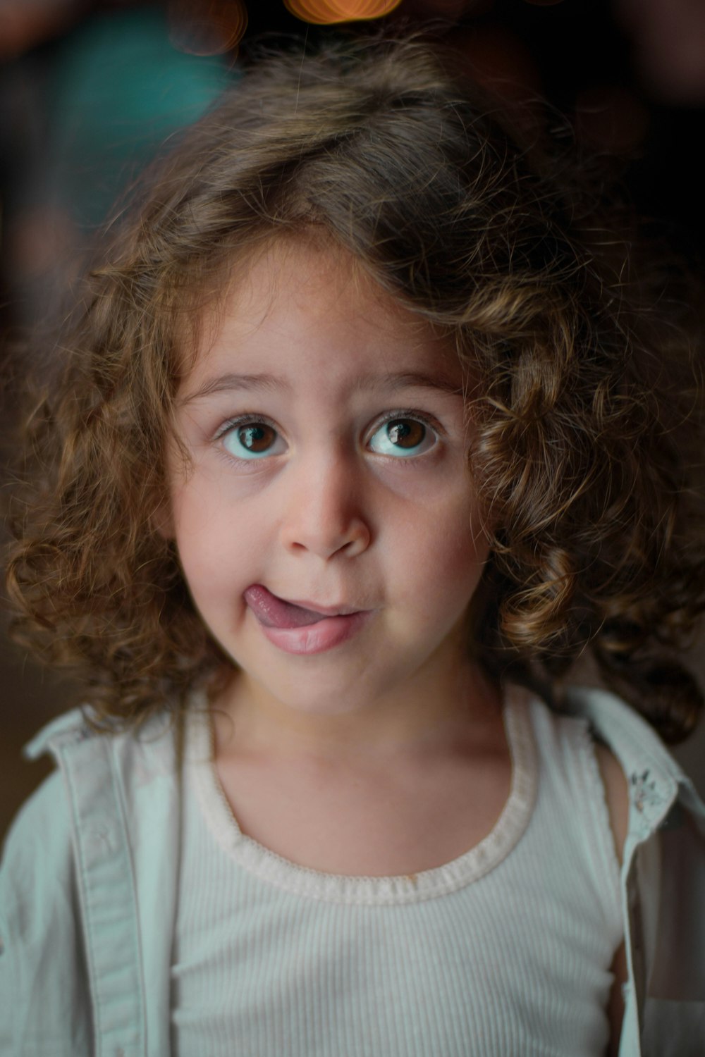 a close up of a young girl with curly hair