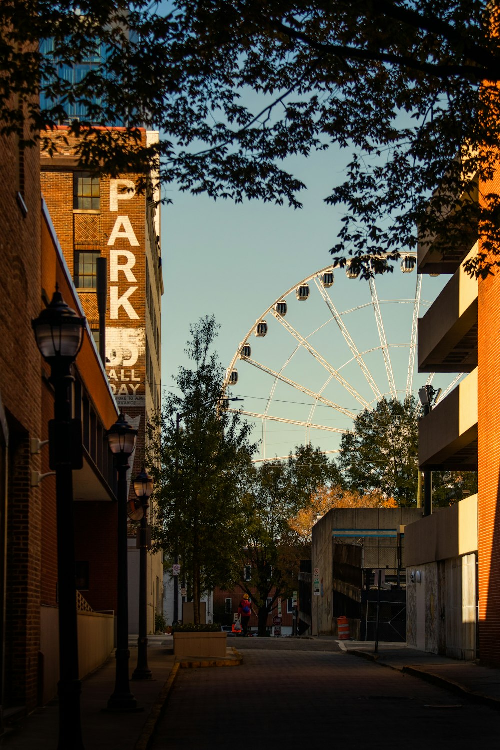 a large ferris wheel sitting next to a tall building