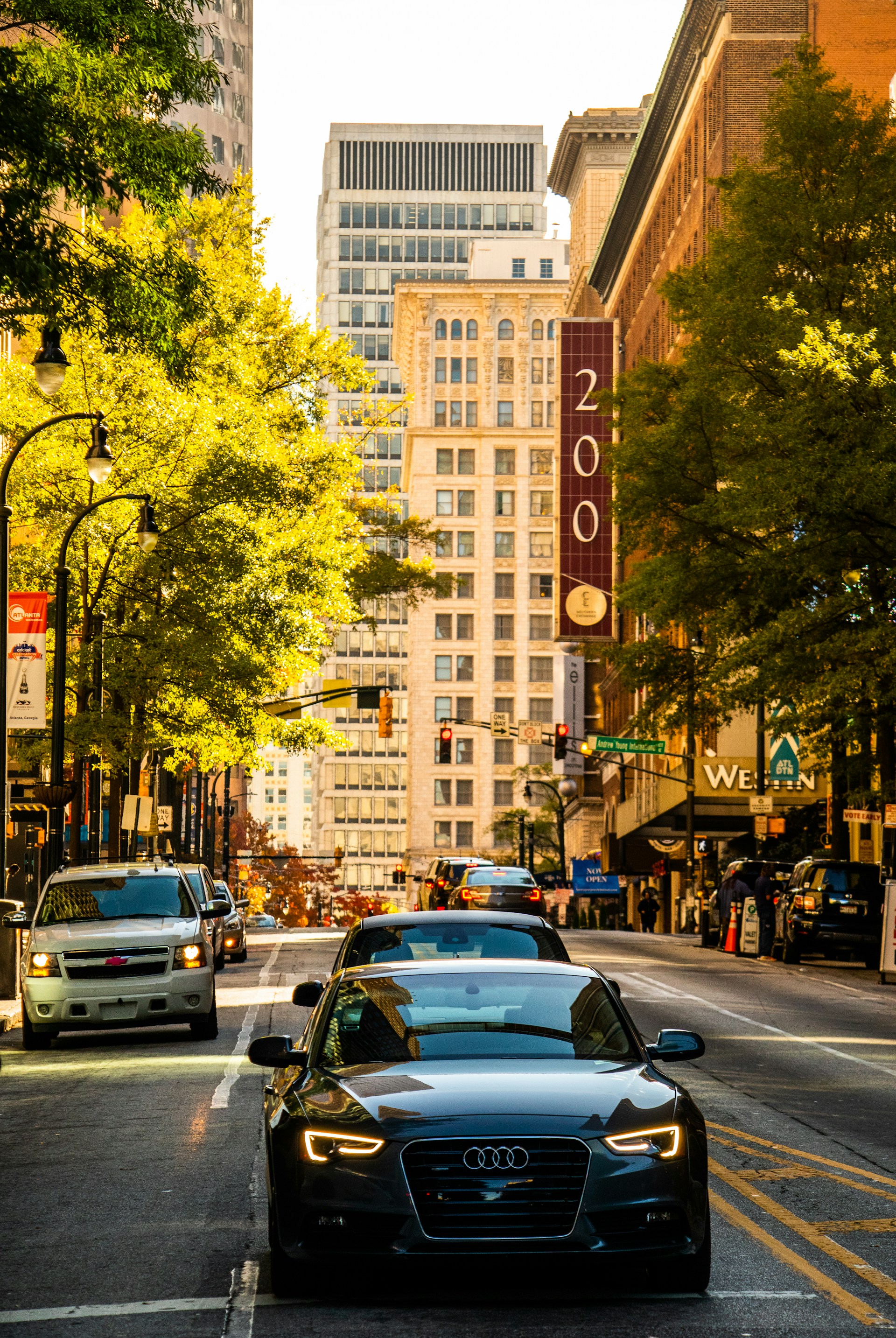 a city street filled with lots of traffic and tall buildings