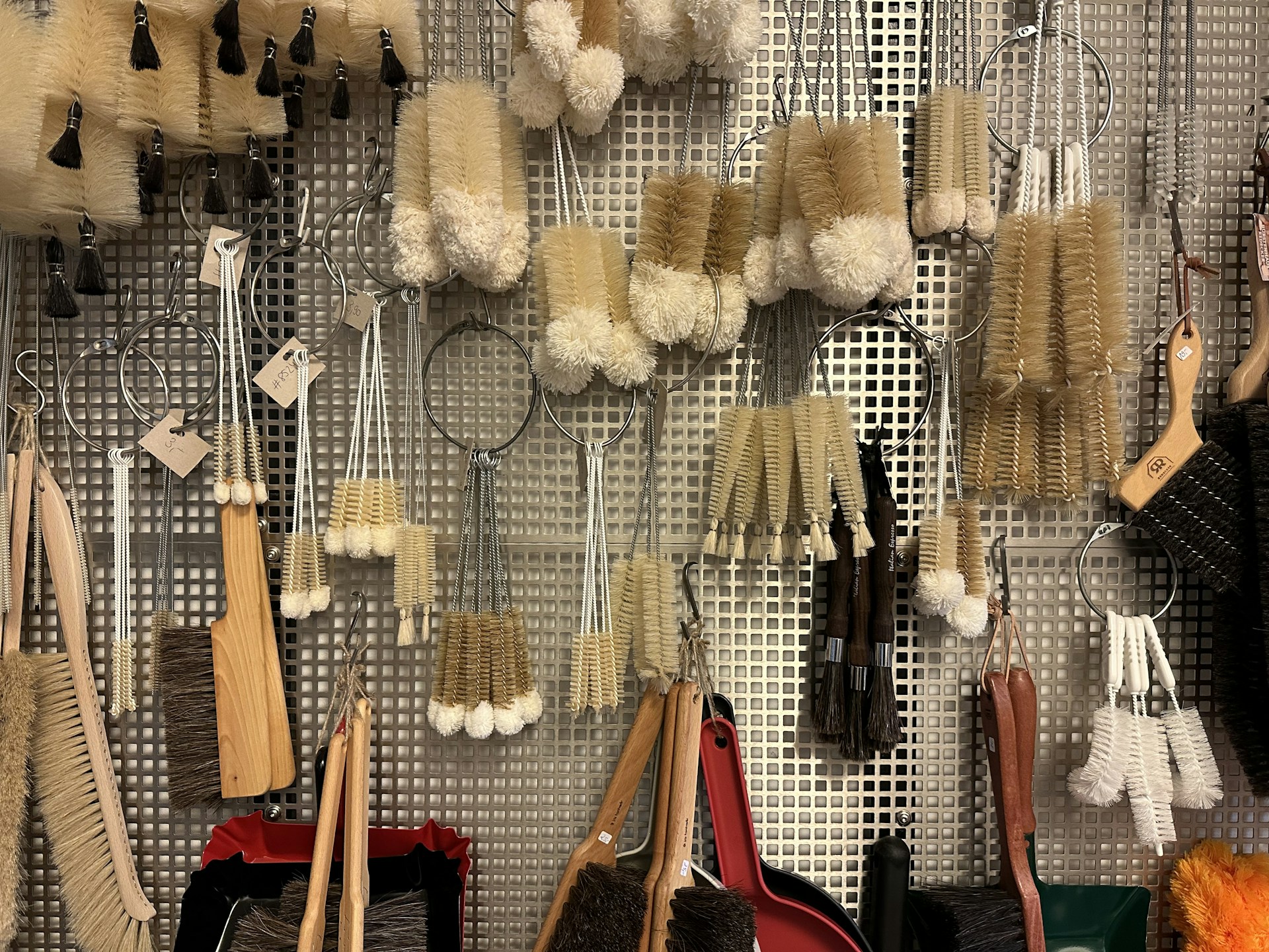 A set of multi-purpose cleaning brushes arranged neatly on a kitchen counter, showing various sizes and bristle types for different tasks.