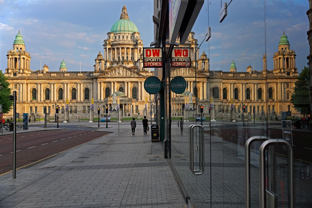 a city street with a large building in the background