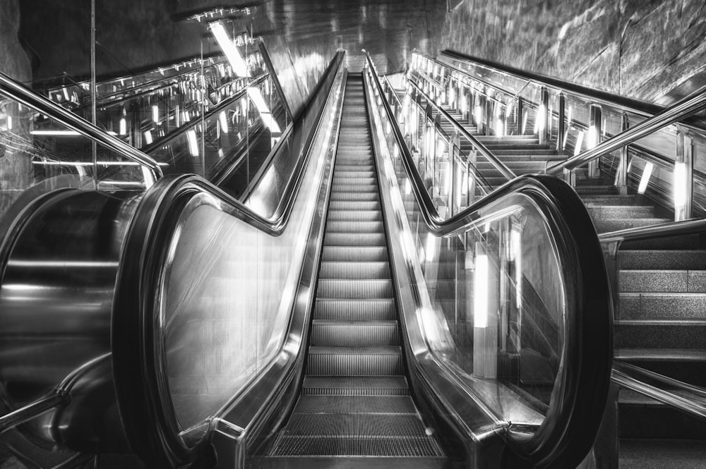 a black and white photo of an escalator