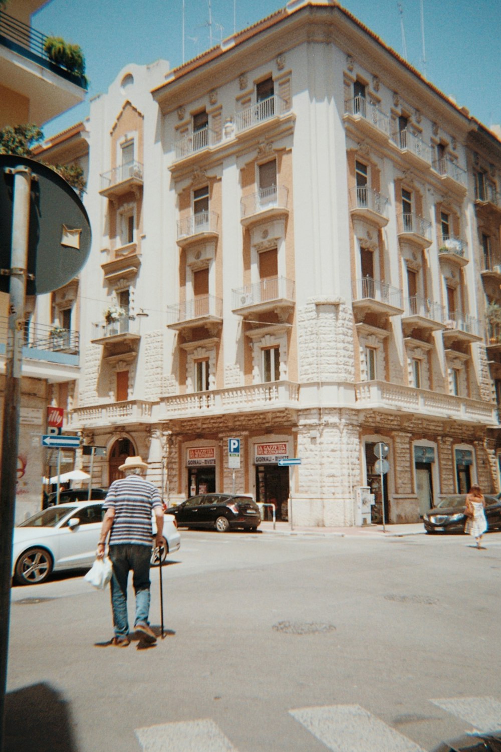 a man riding a skateboard down a street next to a tall building