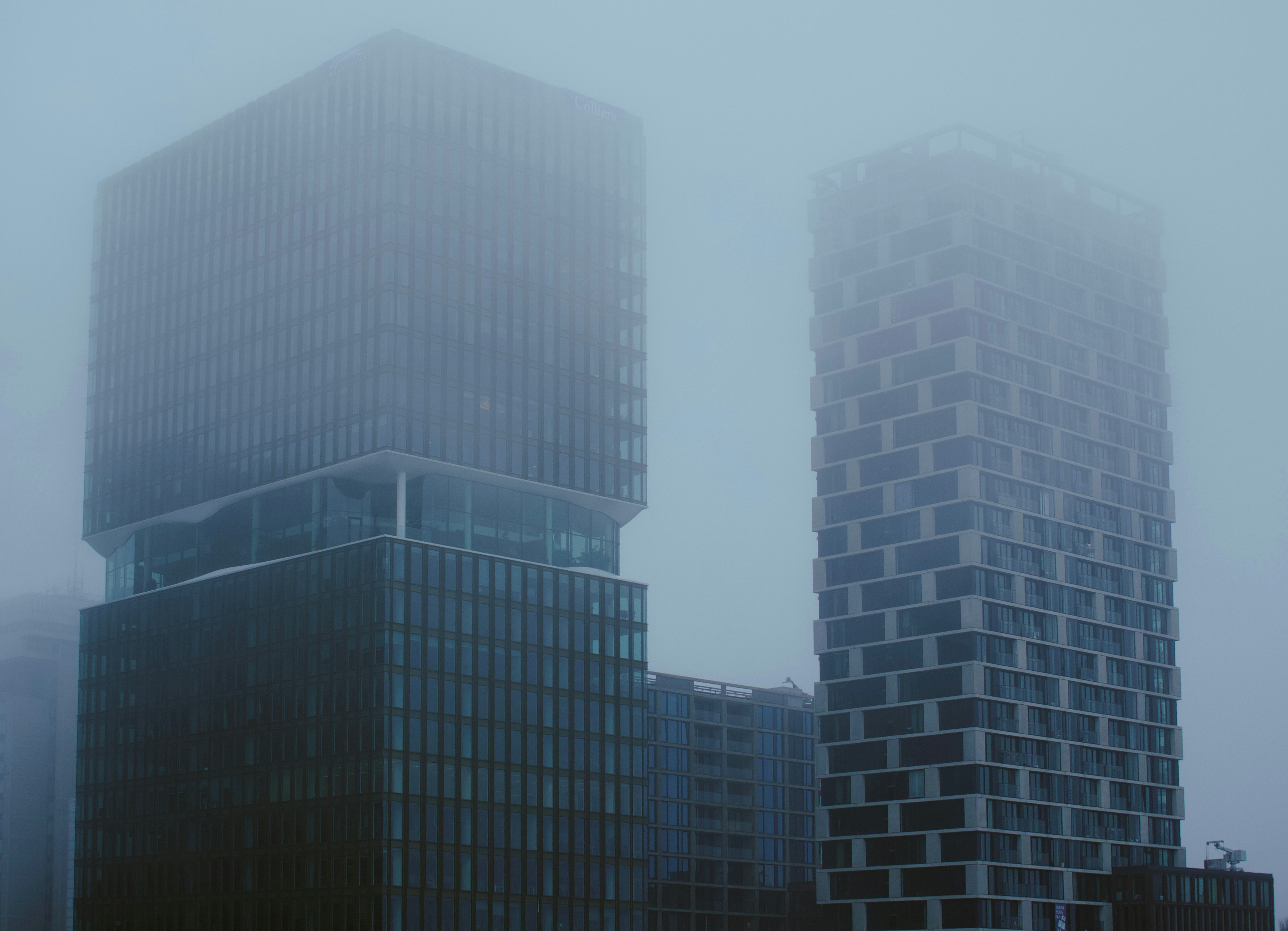 a couple of tall buildings sitting next to each other