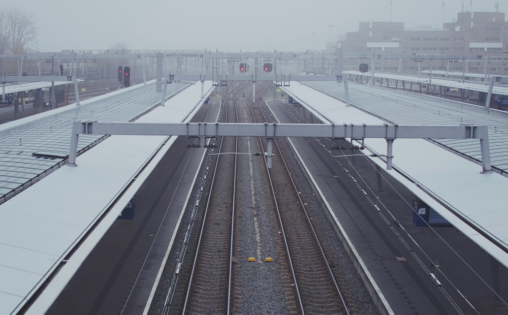 a train station with a lot of tracks covered in snow