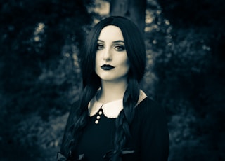 a woman with long black hair and black lipstick