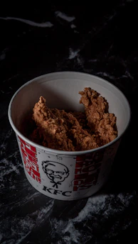 a bowl filled with fried food on top of a table