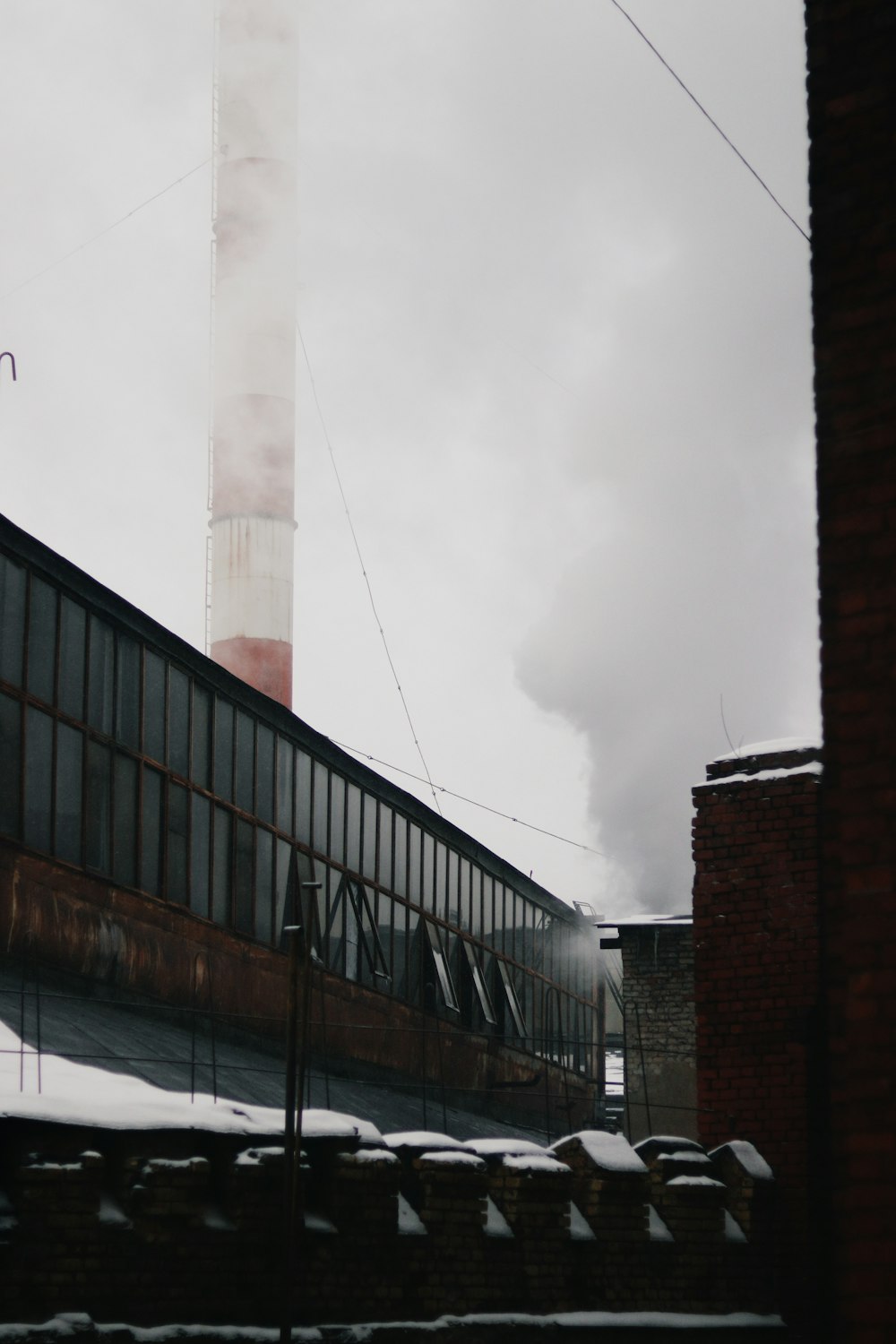 a factory building with smoke coming out of it