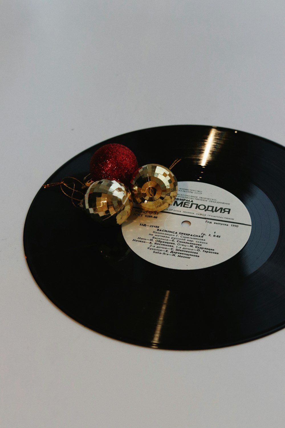 a record with a christmas ornament on top of it