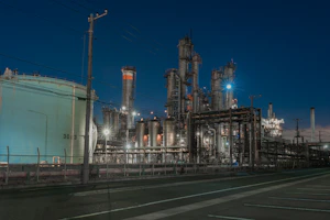a factory with a lot of pipes and lights